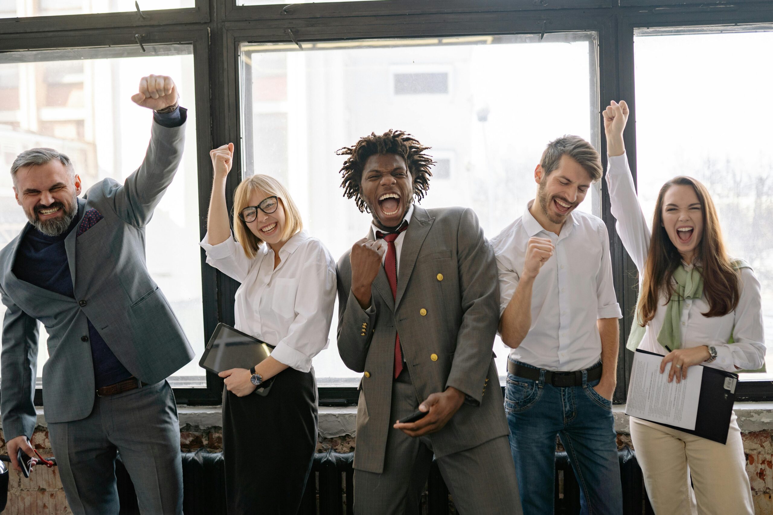 Picture of the team excited, happy together in the office after providing small businesses with digital solutions.