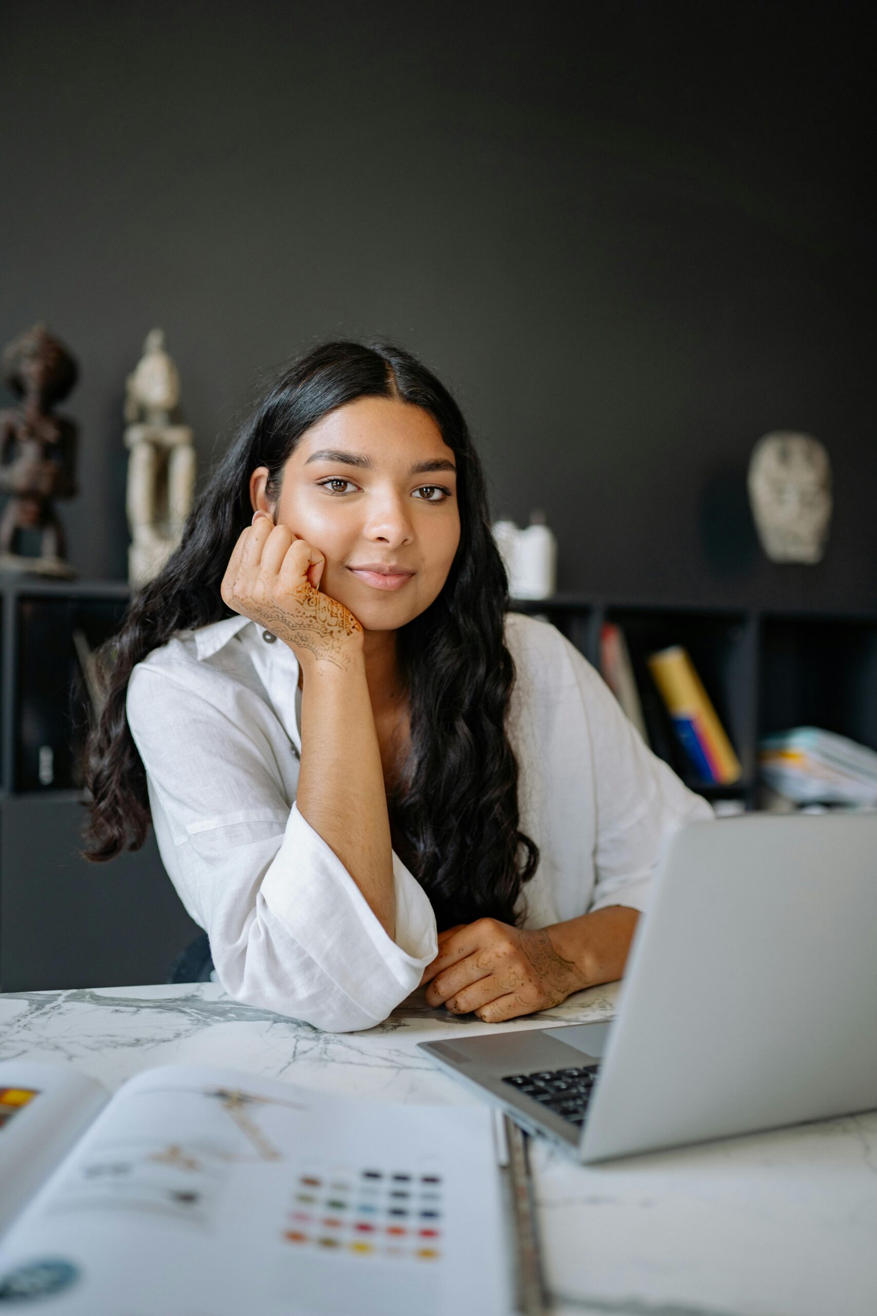 Picture of young woman at a laptop in a dark room.